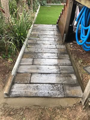 making a cheap walkway from precast concrete pavers to hide an area of the garden where grass will not grow