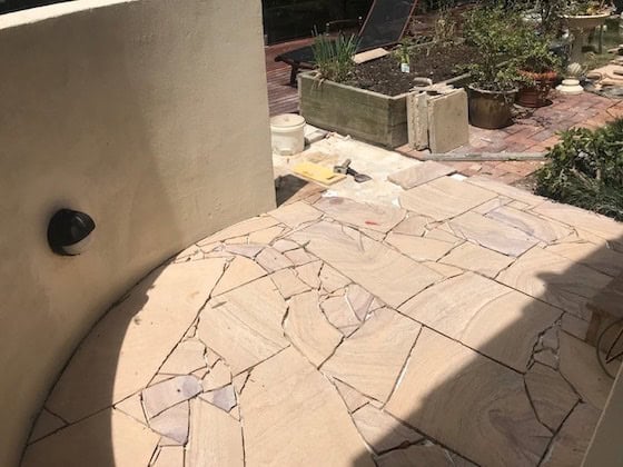 irregular sandstone pathway used to transition from the pool to house